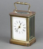 A 19th Century French carriage timepiece with enamelled dial, Roman numerals, contained in a gilt