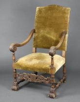 A 17th Century style carved beech open arm chair with upholstered seat and back, carved and
