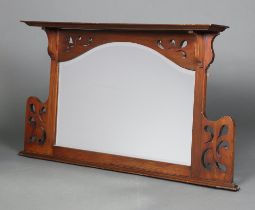 An Art Nouveau arched plate over mantel mirror contained in a pierced mahogany frame 70cm h x
