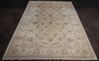 A Caucasian style cream ground floral patterned carpet 537cm x 369cm Light stains in places, signs