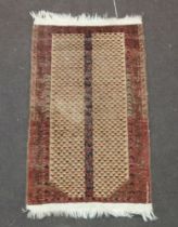 A brown and red ground Belouche rug 114cm x 68cm The rug is showing signs of wear, fringe missing in