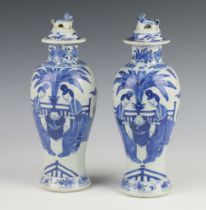 A pair of early 20th Century Chinese blue and white oviform vases and covers decorated with