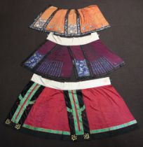 Three Late Qing Dynasty Chinese Han style silk damask skirts including, a purple skirt with 2 half