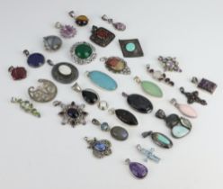 A quantity of silver mounted pendants and brooches