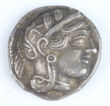 A silver tetradrachm coin of Attica, minted at Athens 450-400 BC, Athena on one side, owl on the