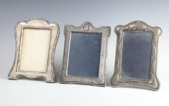 A silver photograph frame Birmingham 1912, 19cm x 14cm, 2 others All have minor dents