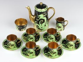 A New Chelsea Staffordshire Art Deco coffee set, the black ground with green and gilt dragon
