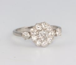 A white metal platinum diamond cluster ring comprising 12 brilliant cut diamonds approx. 1ct, 3.9