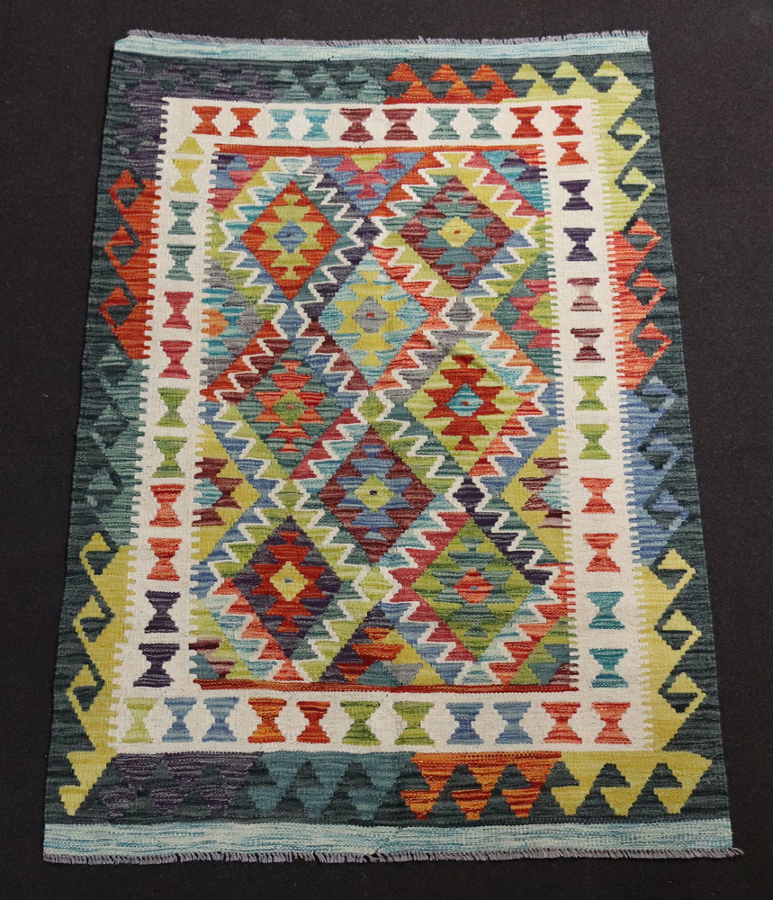 A white and green ground Chobi Kilim with diamond decoration to the centre within multi row border