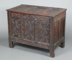 A 17th/18th Century oak coffer of panelled construction and iron lock, the interior fitted a