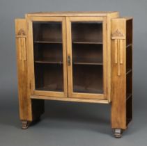 A 1930's Art Deco light oak display cabinet, the centre section fitted shelves enclosed by glazed