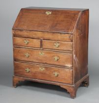 A 17th/18th Century oak bureau, the fall front fitted a well above 2 short and 2 long drawers with