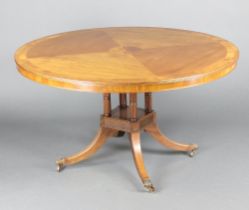A Georgian style circular inlaid and crossbanded mahogany breakfast table raised on 4 turned columns