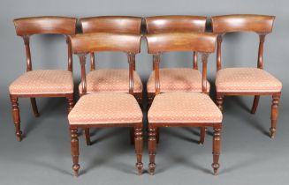 A set of 6 Victorian mahogany bar back dining chairs with overstuffed seats, raised on turned