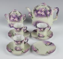 A Continental Art Nouveau tea set decorated with flowers comprising teapot, 3 cups, 4 saucers (1 a/