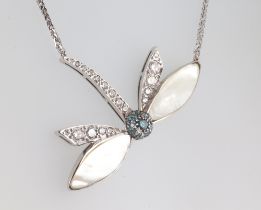 A white metal dragonfly necklace with mother of pearl wings set with brilliant cut diamonds, approx.