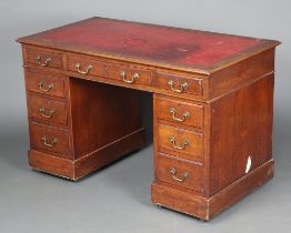 An Edwardian mahogany desk with red inset writing surface above 1 long and 8 short drawers 77cm h