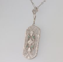 An Art Deco white metal 14k pendant set with diamonds and emeralds on a 14k white metal 40cm