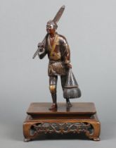 A Japanese Meiji period bronze figure of a standing fisherman with a paddle and creel 24cm, raised