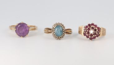 A 9ct yellow gold amethyst ring, a ditto topaz ring and a garnet ring, sizes N, N 1/2 and O 1/2,