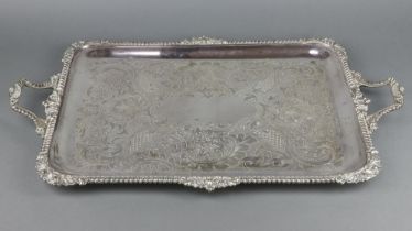 An engraved silver plated 2 handled tray with scroll and floral decoration 73cm