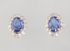 A pair of white metal 18ct oval sapphire and diamond ear studs sapphires 1.52ct diamonds 0.6ct