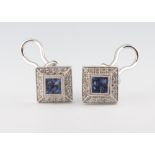 A pair of white metal 750 square sapphire and diamond ear studs (for pierced ears) comprising 8