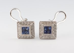 A pair of white metal 750 square sapphire and diamond ear studs (for pierced ears) comprising 8