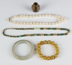 A hardstone bangle (a/f) and 3 others and a snuff bottle