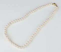 A strand of cultured pearls with a yellow metal 750 clasp 40cm