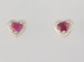 A pair of yellow metal ruby and diamond ear studs 1.3 grams, together with a pair of 9ct paste studs