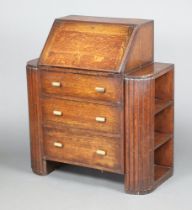 An Art Deco student's oak bureau, the fall front revealing a well fitted interior above 3 long