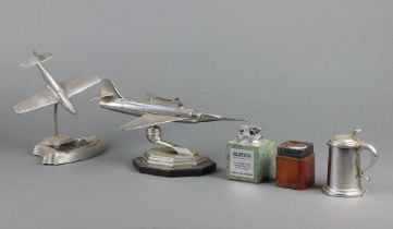 A Dunhill lighter in the form of a lidded tankard 7cm, a lighter in the form of a jet aeroplane (f),