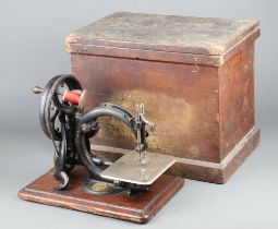 Wilcox and Gibbs, a manual sewing machine, complete with wooden carrying case All moving parts are
