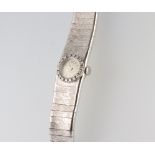 A lady's Facit white metal 750 wristwatch and strap, the bezel set with 18 brilliant cut diamonds,