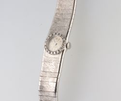 A lady's Facit white metal 750 wristwatch and strap, the bezel set with 18 brilliant cut diamonds,