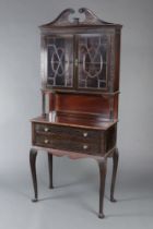 An Edwardian Chippendale style carved mahogany bookcase on cabinet with carved and pierced cornice ,