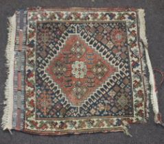 A tan, green and white ground Caucasian slip rug 58cm x 62cm In wear, there is a 9cm section missing