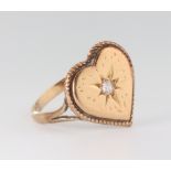 An Edwardian yellow metal heart shaped diamond set ring, the diamond 0.05ct, size K, 2.6 grams