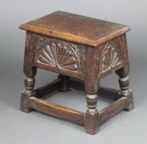 A Victorian rectangular carved oak stool with hinged lid and arcaded decoration, raised on turned