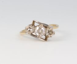 A yellow metal 18ct 3 stone diamond crossover ring, approximately 0.45ct, 2.8 grams, size I