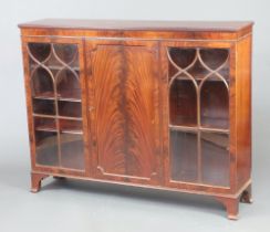 An Edwardian mahogany display cabinet, the centre section fitted shelves enclosed by panelled