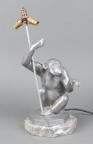 An Art Deco style resin table lamp in the form of a seated chimp, raised on an octagonal grained