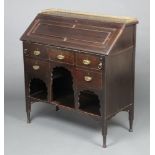 An Edwardian mahogany bureau with brass 3/4 gallery the fall front revealing a fitted interior above