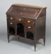 An Edwardian mahogany bureau with brass 3/4 gallery the fall front revealing a fitted interior above