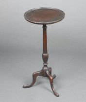 A Georgian style circular mahogany wine table raised on pillar and tripod base 62cm h x 30cm diam.