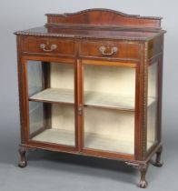 A Chippendale style mahogany display cabinet with raised arched back, fitted 2 long drawers above