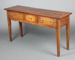 A Continental hardwood dresser base the top formed from planks, fitted 1 short and 2 long drawers,