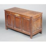 An 18th Century oak coffer of panelled construction with hinged lid and iron lock 64cm h x 110cm w x
