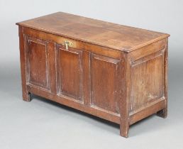 An 18th Century oak coffer of panelled construction with hinged lid and iron lock 64cm h x 110cm w x